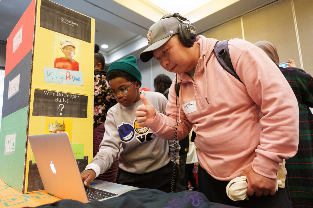 student gets thumbs up review for presenting what he learned